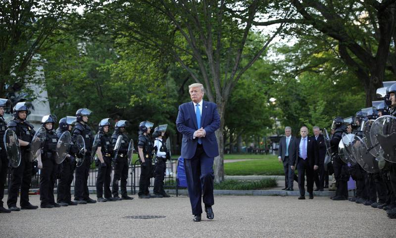 President Donald Trump walks between lines of riot police in Lafayette Park across the White House in Washington after visiting St John's Church for a photo opportunity during the ongoing protests over racial inequality in the wake of the death of George Floyd while in the custody of Minneapolis police. Reuters