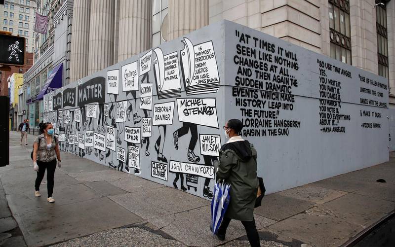 People walk past a mural in Union Square highlighting police brutality nationwide in New York.  EPA