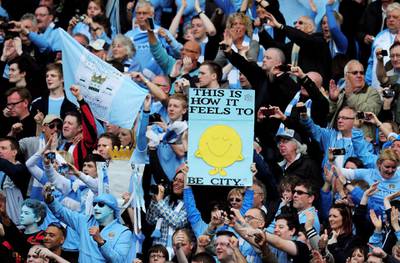 MANCHESTER, ENGLAND - MAY 13:  Manchester City fans celebrate following the Barclays Premier League match between Manchester City and Queens Park Rangers at the Etihad Stadium on May 13, 2012 in Manchester, England.  (Photo by Shaun Botterill/Getty Images)