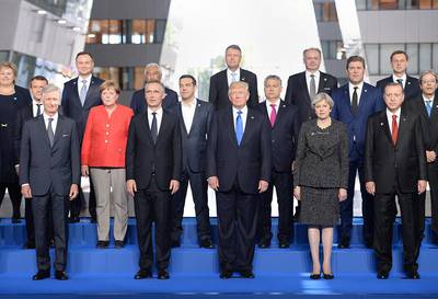 US President Donald Trump with the leaders of Nato member countries and the alliance's secretary general, Jens Stoltenberg (front row, second left), during a summit on May 2017 in Brussels. Stefan Rousseau / Pool / Getty