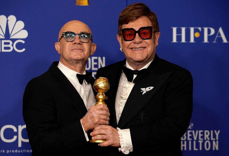 Bernie Taupin and Elton John pose with their awards for Best Original Song - Motion Picture for 'I'm Gonna Love Me Again,' from 'Rocketman' during the 77th annual Golden Globe Awards on January 5, 2020, at The Beverly Hilton hotel in Beverly Hills, California. Reuters