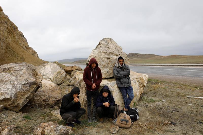 A group of Afghan migrants rest, during a break from their walk, on a main road, after crossing the Turkey-Iran border near Dogubayazit in Agri province, eastern Turkey, April 11, 2018. Picture taken April 11, 2018. REUTERS/Umit Bektas - RC1ED673F5D0