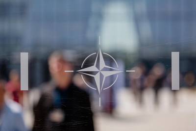 The NATO Star logo sits on a glass panel during the military and political alliance's summit at the North Atlantic Treaty Organization (NATO) headquarters in Brussels, Belgium, on Thursday, July 12, 2018. In an unexpected twist, NATO leaders held an unplanned emergency session on the last day of their two-day summit, which has been upended by U.S. President Donald Trump's attacks on allies over defense spending. Photographer: Marlene Awaad/Bloomberg