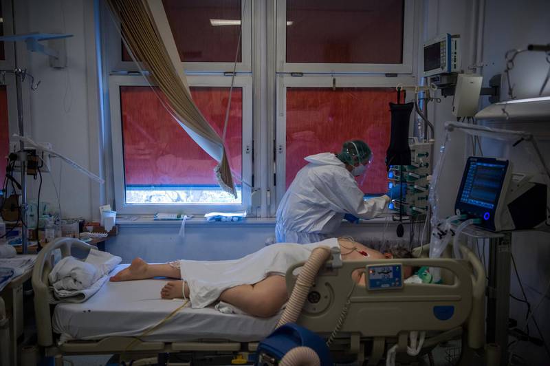 A doctor wearing protective gear takes care of a COVID-19 patient resting with oxygen assistance at the intensive care unit of Honved Hospital during the coronavirus pandemic in Budapest, Hungary. EPA