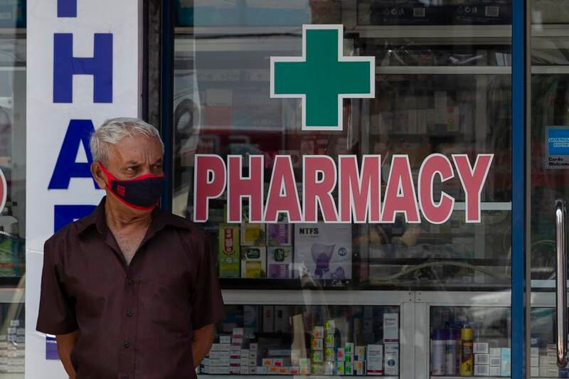 A man stands outside a pharmacy in Colombo. Getty Images