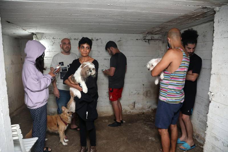 People take shelter in the basement of a building in the Israeli city of Tel Aviv as alarm sirens wailed after 3:00 a.m. after rockets were launched towards Israel from the Gaza Strip. AFP