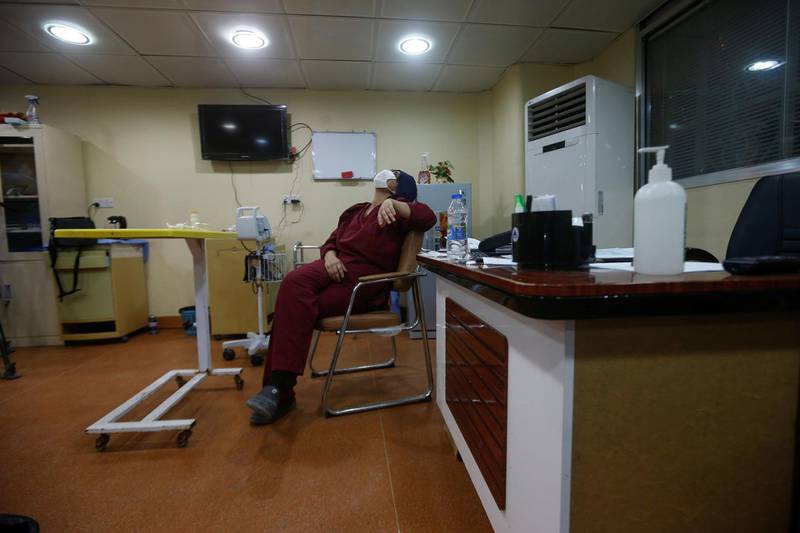 An assistant of Dr Hiba Jabbar Ashoor wears a protective face mask while taking a break at Basra Teaching Hospital, following the outbreak of the coronavirus disease, in Basra, Iraq. Reuters