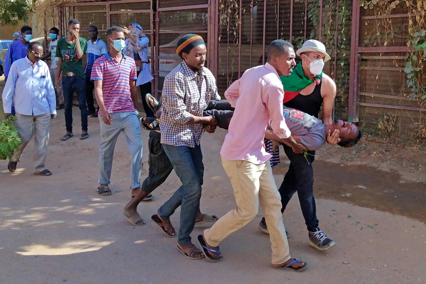Sudanese protesters carry a wounded man away from clashes with security forces in Khartoum's twin city of Umm Durman, where violence is continuing on the streets. AFP