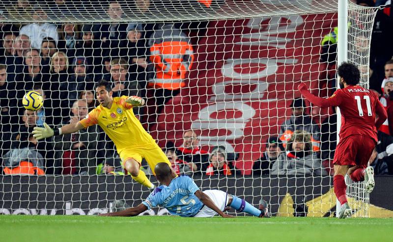 Mohamed Salah, right, scores Liverpool's second goal past Manchester City goalkeeper Claudio Bravo at Anfield. EPA