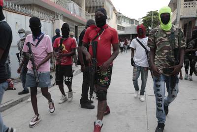 Armed members of 'G9 and Family' march in a protest against Haitian Prime Minister Ariel Henry in Port-au-Prince, Haiti. AP