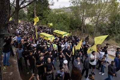 Men carrying the coffins at a funeral for two Hezbollah soldiers killed in south Lebanon. Getty Images