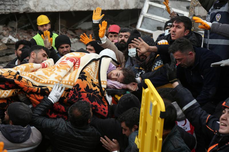 Rescuers carry a girl from a collapsed building, in Diyarbakir, Turkey. Reuters