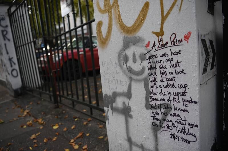 Graffiti commemorating the birthday of John Lennon on the wall of Abbey Road Studios. Music fans come from around the world to pen tributes on the exterior walls. EPA