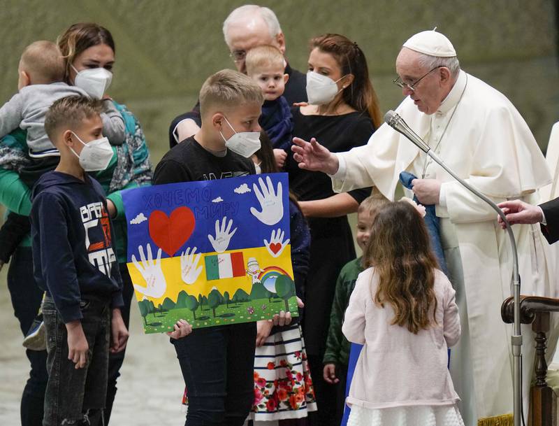 Pope Francis greets child refugees from Ukraine during his weekly general audience at the Vatican. AP