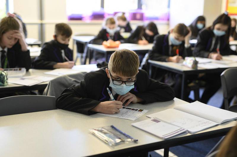 Year 8 students wear masks during class at the Park Lane Academy in Halifax, England. AFP