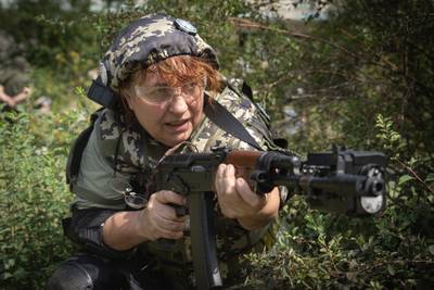 A Ukrainian woman practices with a rifle during volunteer military training for civilians near Kyiv. AP