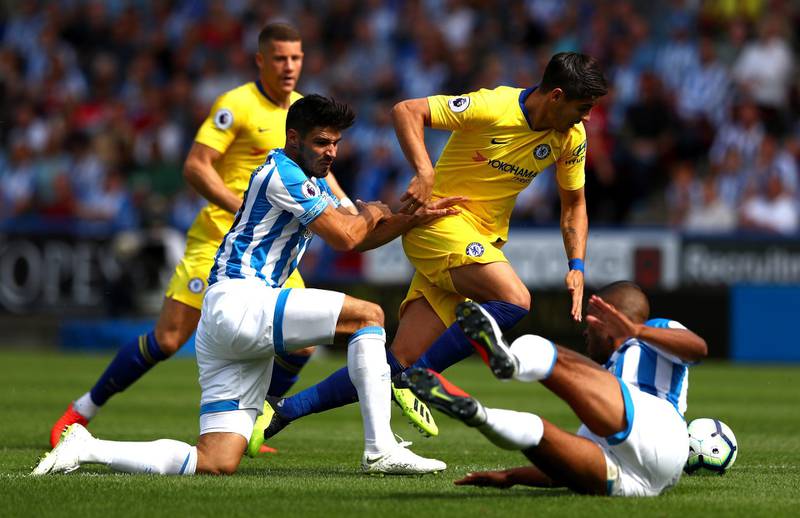 Alvaro Morata of Chelsea is challenged by Christopher Schindler and Mathias Zanka Jorgensen of Huddersfield Town. Getty Images