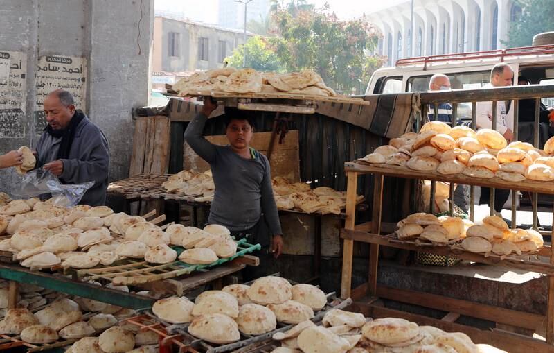 A young Egyptian worker carries a rack loaded with  bread at Bulaq district in Cairo, Egypt. EPA