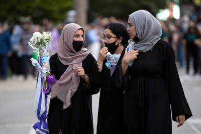 Women attend the vigil. AFP