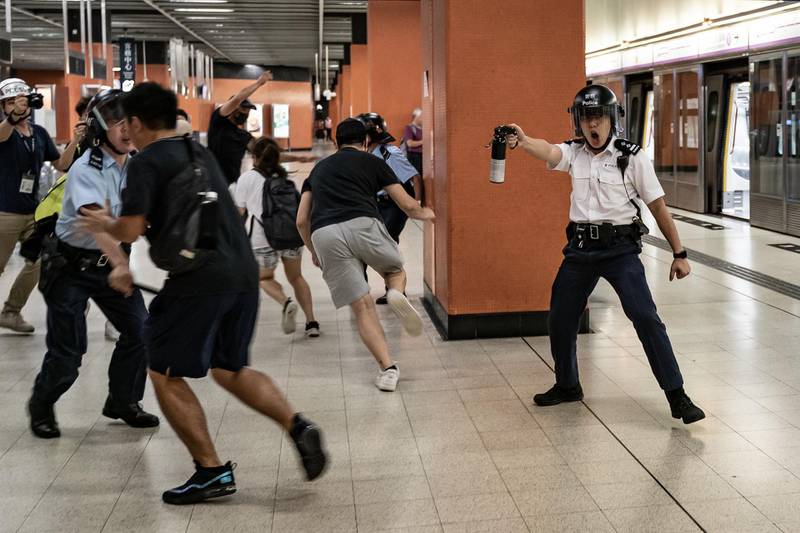 HONG KONG, CHINA - SEPTEMBER 5: A police officer holds up pepper spray as he attempts to disperse protesters out of the platform at Po Lam Station on September 5, 2019 in Hong Kong, China. Pro-democracy protesters have continued demonstrations across Hong Kong since 9 June against a controversial bill which allows extraditions to mainland China, as the ongoing protests, many ending up in violent clashes with the police, have surpassed the Umbrella Movement from five years ago and become the biggest political crisis since Britain handed its onetime colony back to China in 1997. Hong Kong's embattled leader Carrie Lam announced the formal withdrawal of the controversial extradition bill on Wednesday, meeting one of protesters' five demands after 13 weeks of demonstrations. (Photo by Anthony Kwan/Getty Images)