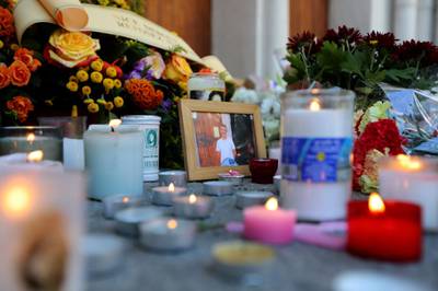 Tributes to one of the victims outside the church. AFP