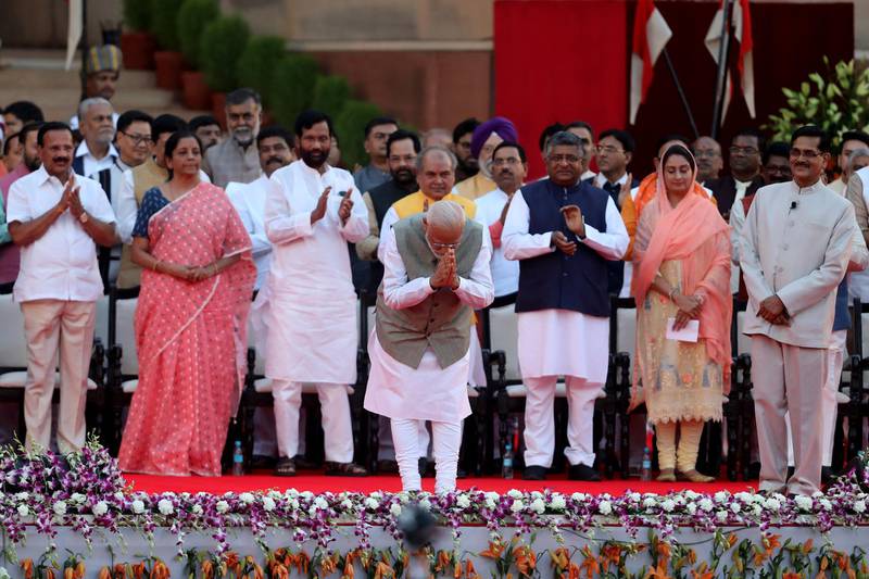 Narendra Modi, India's prime minister, center, gestures during a swearing in ceremony for the prime minister and other members of the cabinet at the Presidential Palace in New Delhi, India, on Thursday, May 30, 2019. Modi's thumping victory in India's election, which saw the ruling Bharatiya Janata Party win 303 seats in the 543-member parliament, provided him with a single party majority and raised expectations that he will turn to reforms that eluded him in his first term in office. Photographer: T. Narayan/Bloomberg