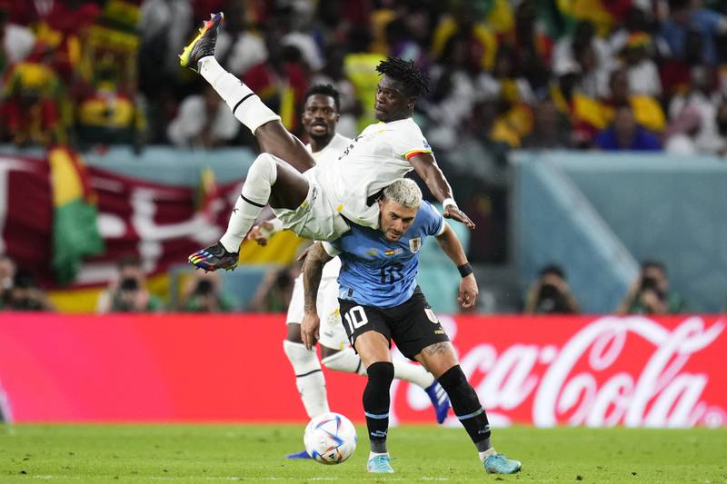 Ghana's Seidu, left, and Uruguay's De Arrascaeta challenge for the ball. AP Photo
