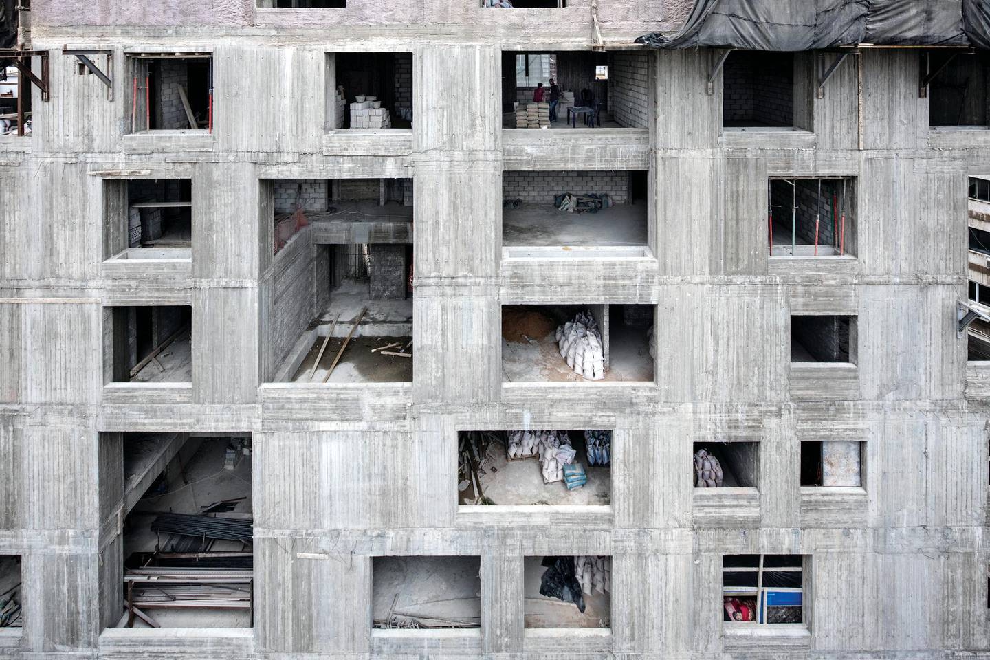 One of the images of a building under construction captures a man asleep on a makeshift bed. Ieva Saudargaite Douaihi