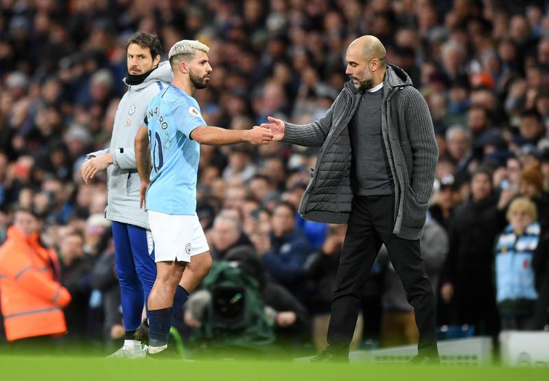 Guardiola congratulates Aguero as he substitutes the Argentine following his hat-trick. Getty