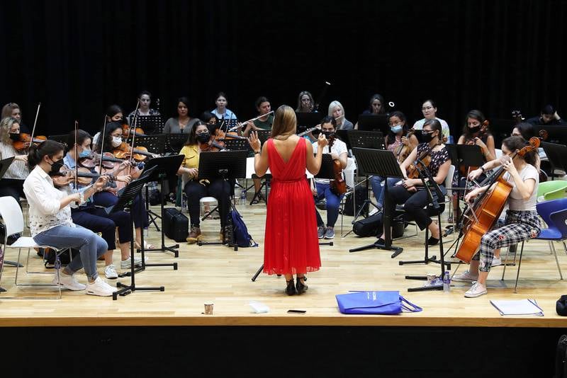 Yasmina Sabbah, from Lebanon, conducts during rehearsals at the Gems Wellington School in Dubai. Pawan Singh / The National
