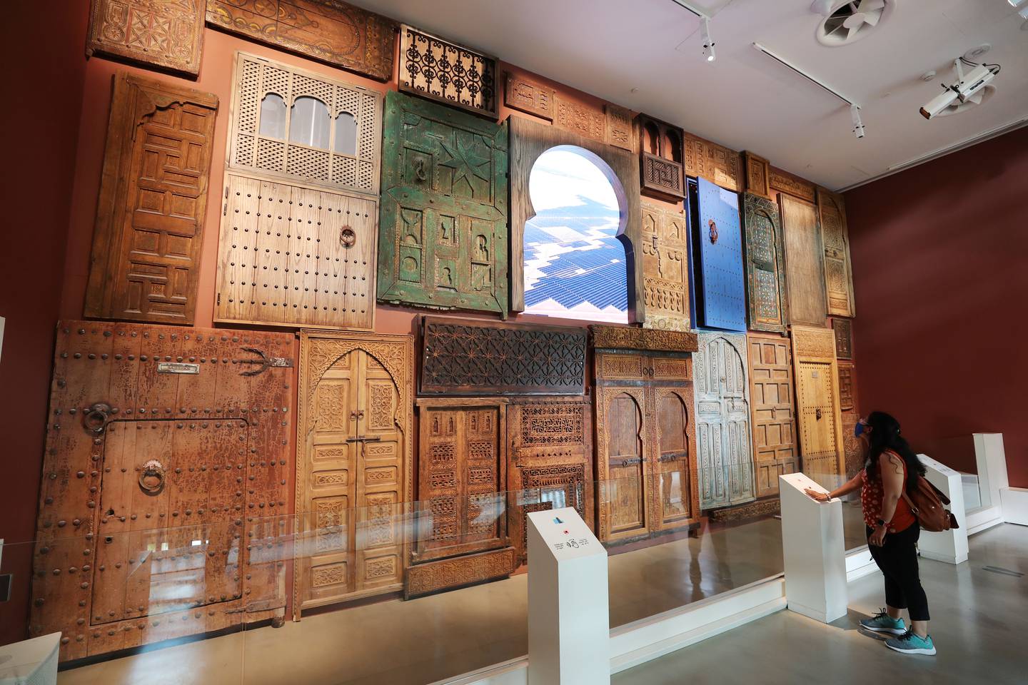 A room full of old, large wooden doors that open with information bout green energy at the Morocco Pavilion. Chris Whiteoak / The National