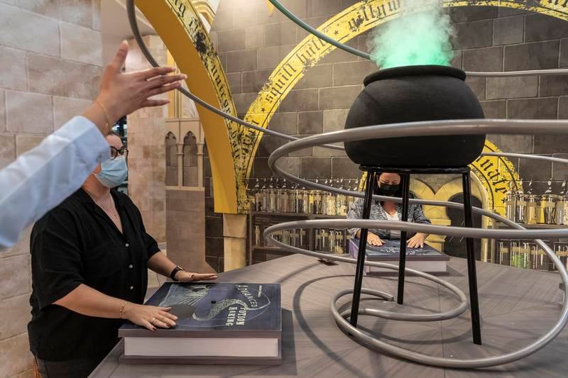 Try your hand at a potions class, which activates the cauldron and generates a cloud of green smoke.