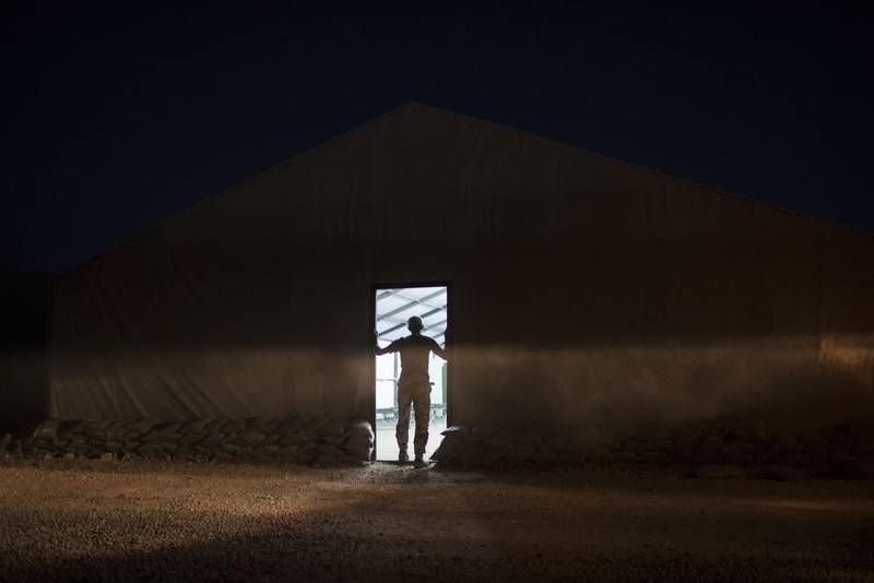 An Iraqi army soldier stands at the entrance of a tent at the Qayara air base, south of Mosul. Felipe Dana / AP Photo