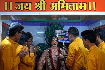 Fans of Bollywood actor Amitabh Bachchan offer prayers at a temple on his 81st birthday in Kolkata. AFP
