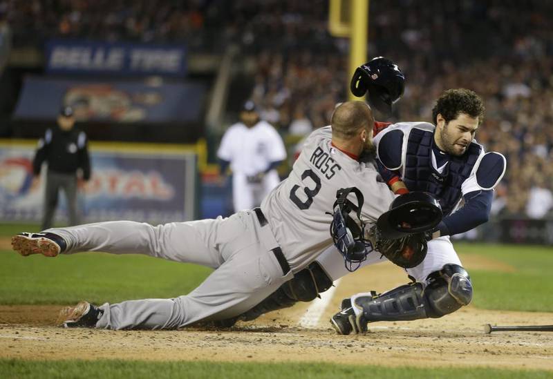 MLB is not interested in establishing a law that would eliminate a collision such as the one Boston Red Sox's David Ross had at home plate with Detroit Tigers catcher Alex Avila. Ross, by the way, was out. But Avila was out, too ... he eventually left the game with an injured knee. Matt Slocum / AP Photo


