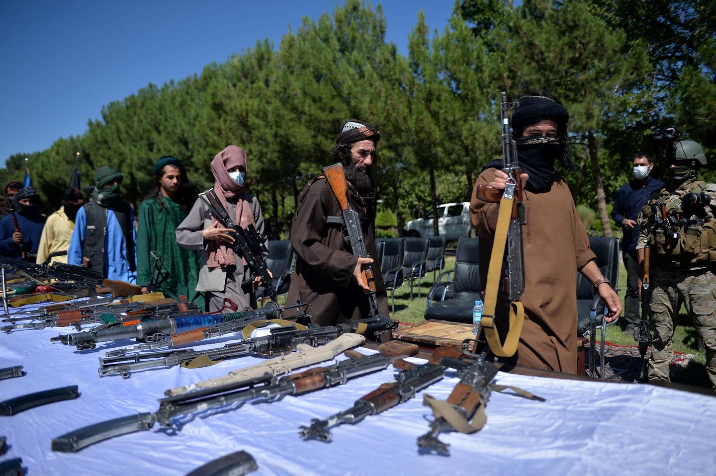 Taliban fighters lay down their weapons during a ceremony in Herat as they surrender to join the Afghanistan government. AFP