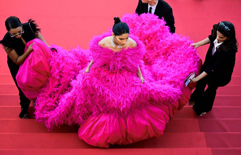 A guest arrives to attend the screening of 'Final Cut (Coupez !)' ahead of the opening ceremony of the Cannes Film Festival in southern France. AFP
