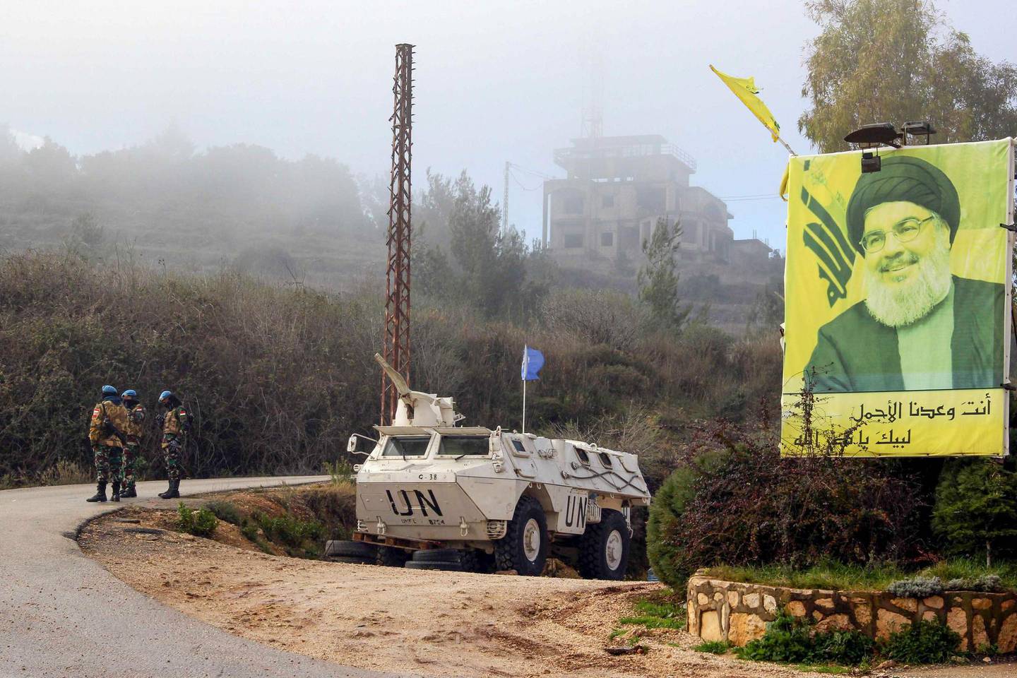 A United Nations Interim Forces in Lebanon (UNIFIL) armoured vehicle is parked under a portrait of Hezbollah leader Hassan Nasrallah on a side road in the southern Lebanese town of Kfar Kila near the border with Israel on January 3, 2020. Following this morning's killing of Iranian commander, Major General Qasem Soleimani, Lebanon's Iran-backed Hezbollah movement called for the missile strike by Israel's closest ally, to be avenged. "Meting out the appropriate punishment to these criminal assassins... will be the responsibility and task of all resistance fighters worldwide," Hezbollah chief Hassan Nasrallah said in a statement.
 / AFP / Ali DIA
