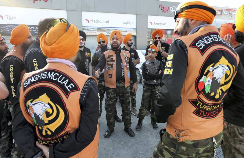 DUBAI ,  UNITED ARAB EMIRATES , May 17 – 2019 :- Members of the SMC ( Singhs Motorcycle Club UAE ) getting ready for the morning bike ride from ENOC gas station on Hatta – Oman road in Dubai. They are into charity events also. This Club was founded by Gurnam Singh ( center ) and Tanuj Singh in 2014. They ride every Friday morning in different parts of the UAE. Gurnam Singh briefing the ridders before the start of the bike ride. ( Pawan Singh / The National ) For Arts&Culture/Big Picture/Instagram/Online. Story by Kate