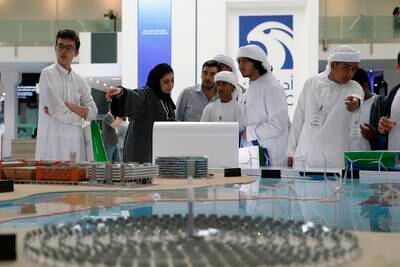ABU DHABI, UNITED ARAB EMIRATES -17January 2017 - School children looks at a model of Solar panels displayed at Masdar stall at the World Future Energy Summit 2017, at the Abu Dhabi Exhibition Center. Ravindranath K / The NationalID: 62760 (to go with LeAnne Graves, Dania Al Saadi and Tony McAuley story for Business) *** Local Caption ***  RK1701-WFES09.jpg