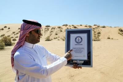 Majed Alsolaim, chief executive of Al Ghadha Parks, shows the Guinness World Record certificate for largest saxaul botanical garden held by the park.