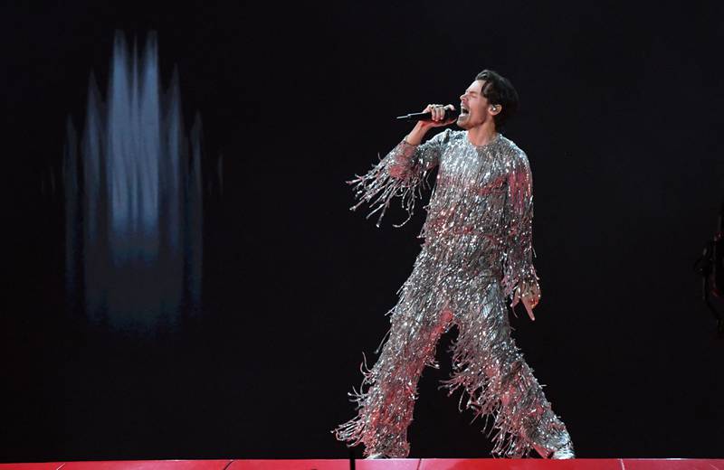 Harry Styles performs in a silver Gucci jumpsuit. AFP