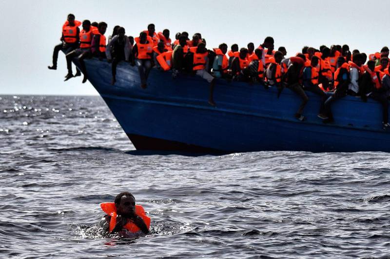 Migrants wait to be rescued as they drift in the Mediterranean Sea some 20 nautical miles north off the coast of Libya. Italy coordinated the rescue of more than 5,600 migrants off Libya, three years to the day after 366 people died in a sinking that first alerted the world to the Mediterranean migrant crisis. Aris Messinis / AFP