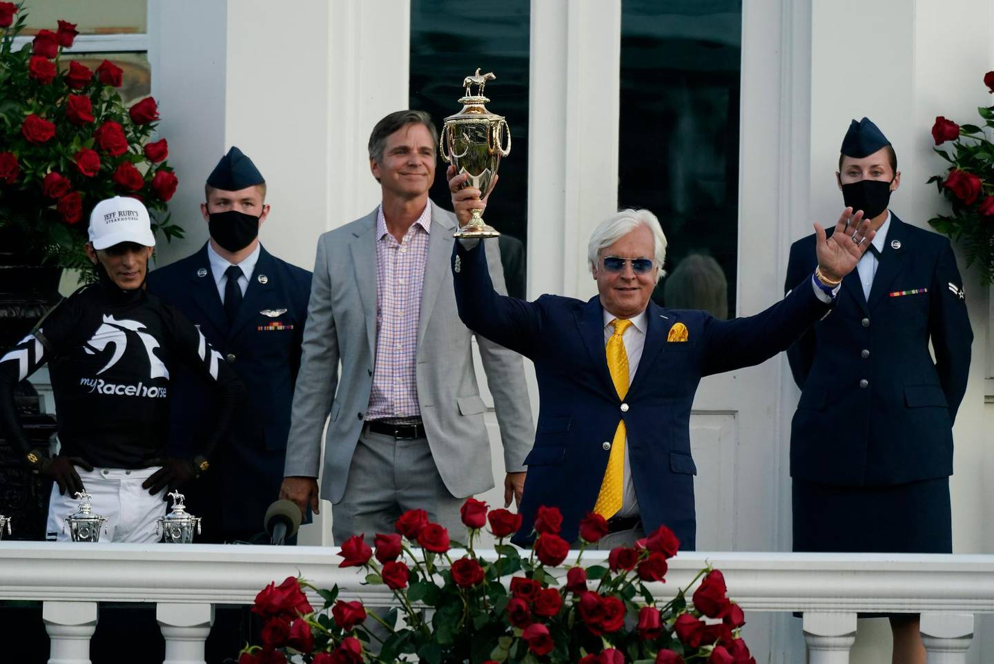Trainer Bob Baffert holds the trophy after John Velazquez, left, rode Authentic to victory in the 146th running of the Kentucky Derby at Churchill Downs, Saturday, Sept. 5, 2020, in Louisville, Ky. (AP Photo/Jeff Roberson)