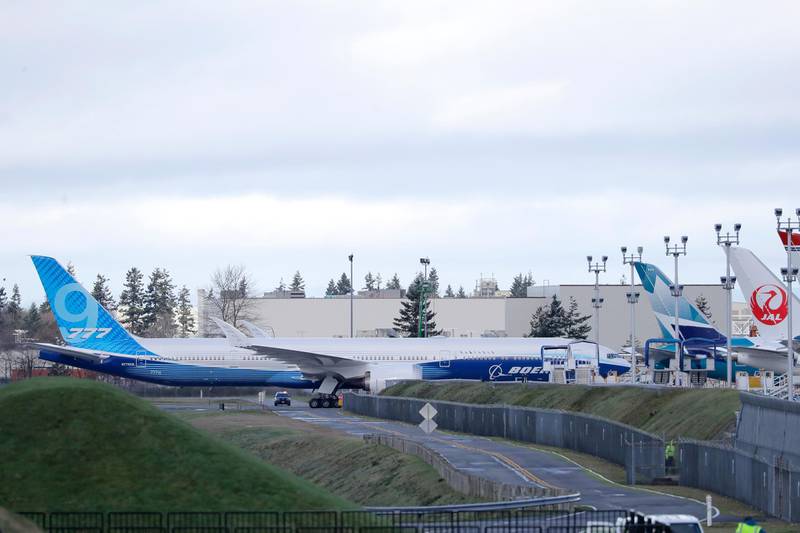 The Boeing 777X airplane taxis back to a parking spot after weather conditions prevented it from making its first flight. The plane sat on the runway for several hours, but was unable to take off due to high wind and other conditions. The flight was rescheduled for Saturday. AP Photo