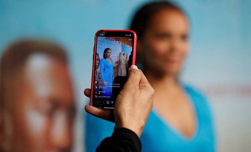 An Instagram Live video is streamed on a smartphone as cast member Carmen Ejogo poses at the premiere for season 3 of the television series "True Detective" in Los Angeles, California, U.S., January 10, 2019. REUTERS/Mario Anzuoni
