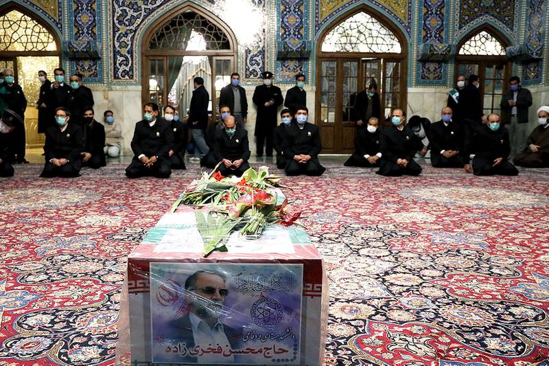 A coffin with an image of Iranian nuclear scientist Mohsen Fakhrizadeh, can be seen among the servants of the holy shrine of Imam Reza in Mashhad. WANA via REUTERS