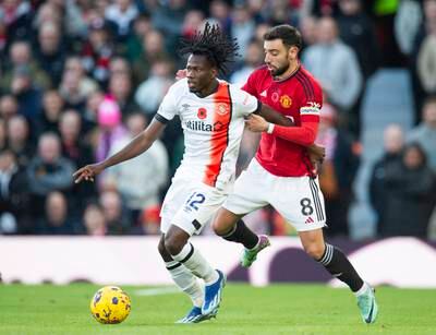 Issa Kabore of Luton Town takes on Bruno Fernandes of Manchester United. EPA
