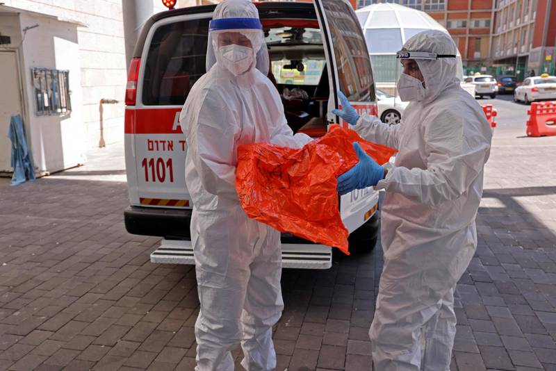 Medics transfer the belongings of a Covid-19 patient to the Hadassah Ein Kerem Hospital in Jerusalem.
