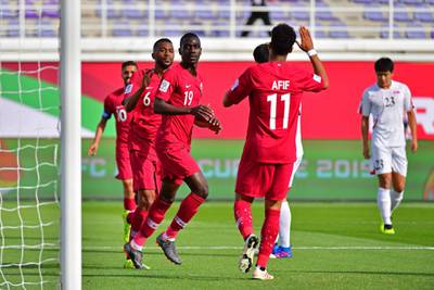 Qatar forward Almoez Ali, third left, celebrates after scoring against North Korea. AFP